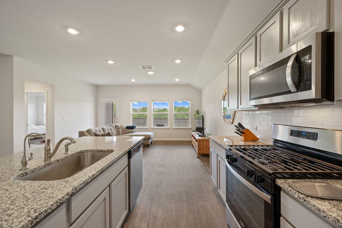 13908 Mamie Eisenhower Road Manor, TX 78653 - Photo 7 of 23 a kitchen with sink stove top oven and microwave