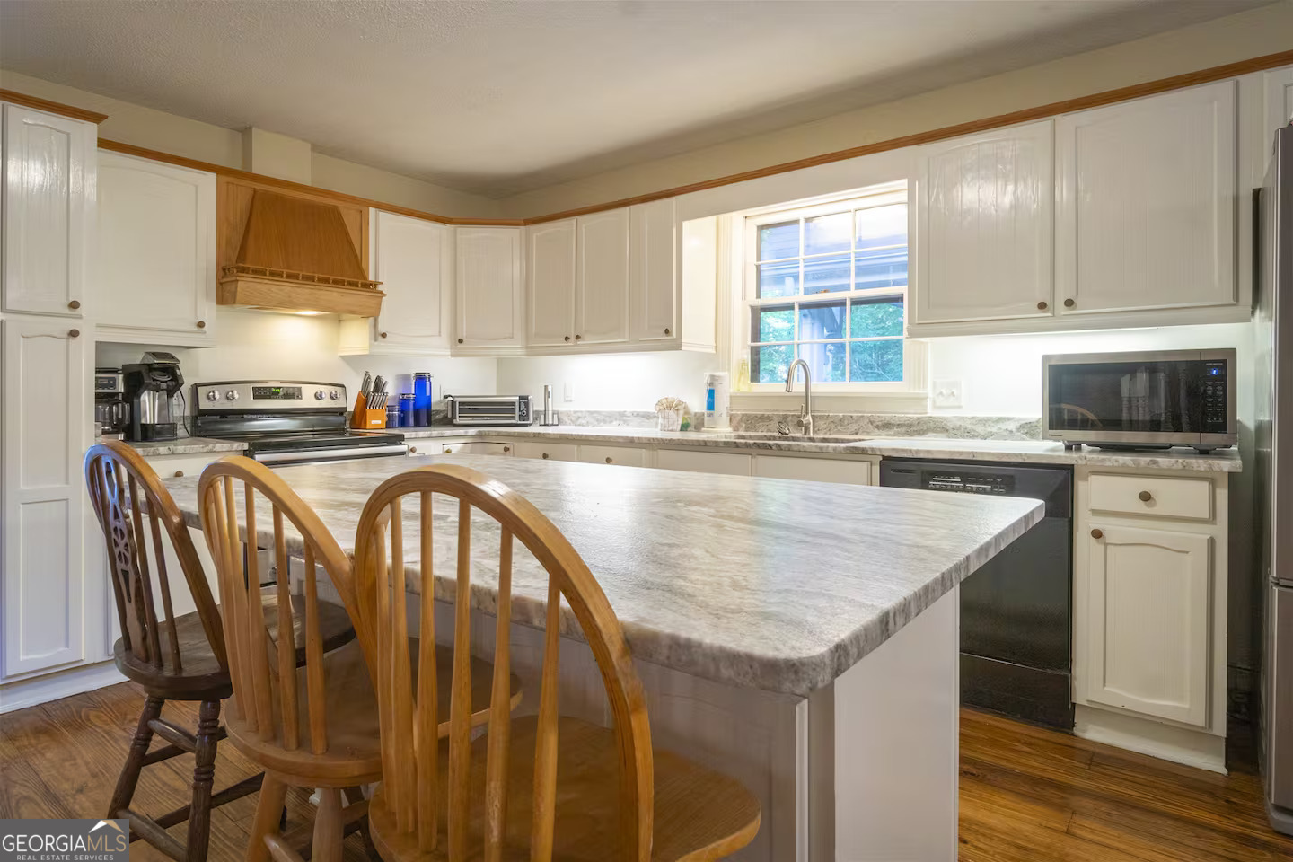 144 Fussen Strasse Helen, GA 30545 - Photo 12 of 38 a kitchen with stainless steel appliances granite countertop a stove a sink a microwave refrigerator and cabinets