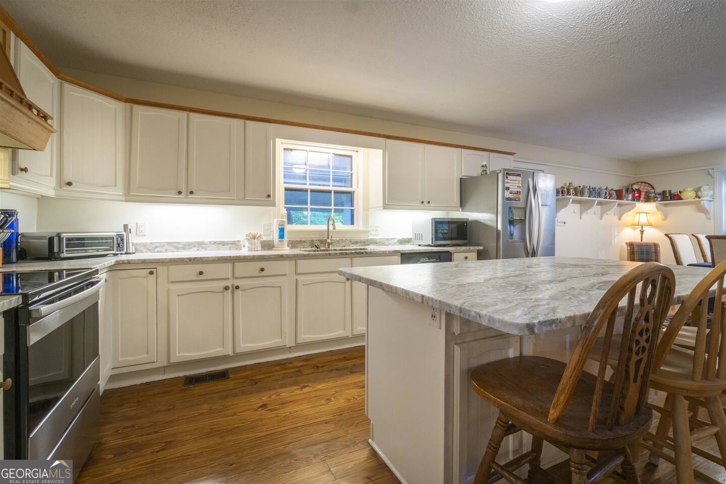 144 Fussen Strasse Helen, GA 30545 - Photo 13 of 38 a kitchen with granite countertop cabinets sink and stainless steel appliances