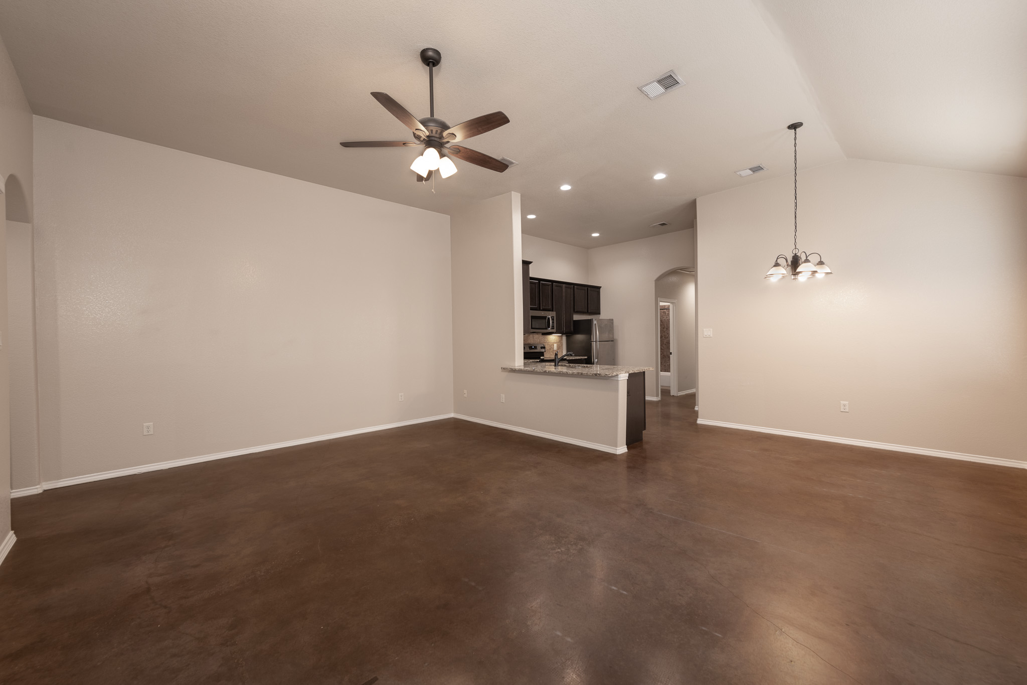 424 Jack Rabbit Lane, Unit B Buda, TX 78610 - Photo 7 of 20 a view of an empty room with a kitchen