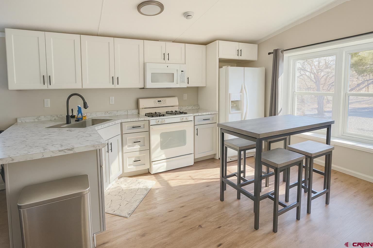 676 Highway 50, Unit SPACE 44 Delta, CO 81416 - Photo 4 of 29 a kitchen with stainless steel appliances granite countertop a stove a sink dishwasher and a refrigerator with wooden cabinets