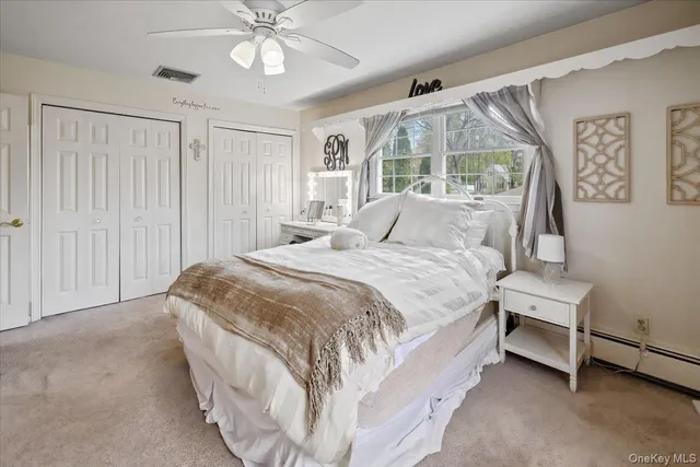 a spacious bedroom with a bed and a chandelier