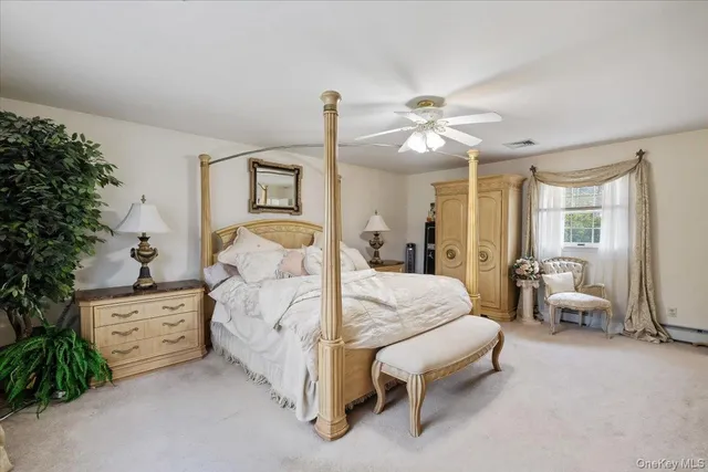 a spacious bedroom with a bed and a chandelier