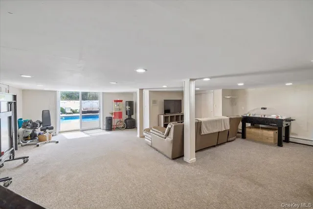 a view of a livingroom with furniture and a gym