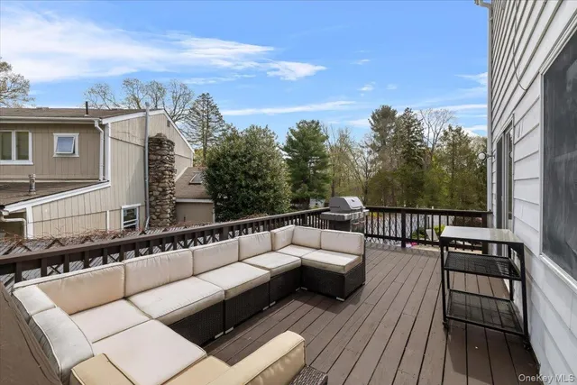 a balcony with wooden floor and furniture