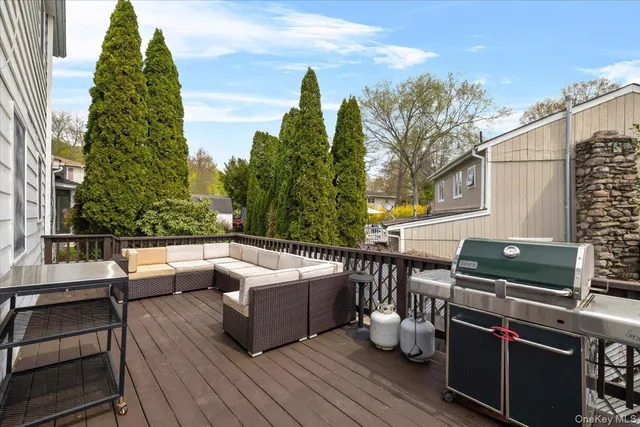 a roof deck with couches and wooden floor