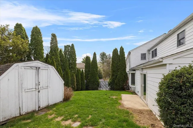 a view of a house with a yard and garage