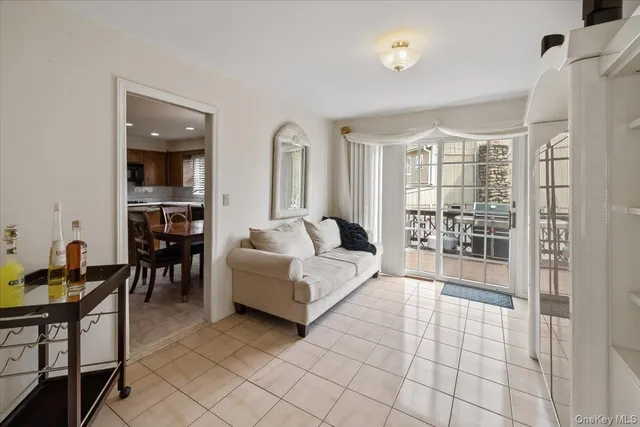 a living room with furniture and a dining table with wooden floor