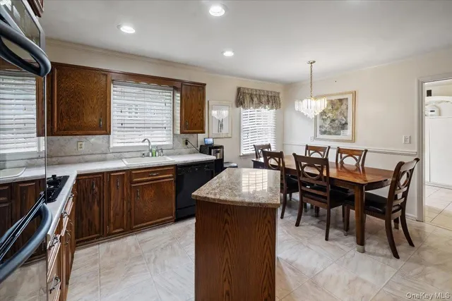 a kitchen with granite countertop sink stove dining table and chairs