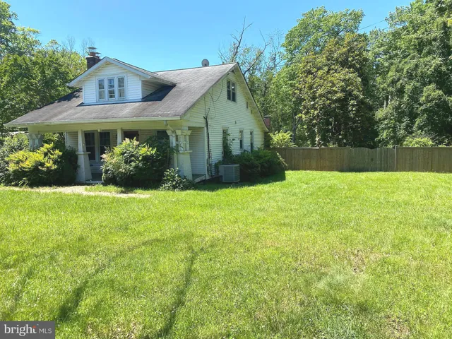 a front view of house with yard and trees