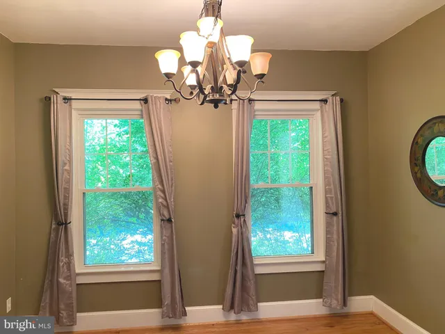 a view of a chandelier in a hall with a window