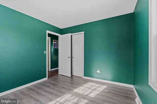 a view of a house with a big yard and large trees