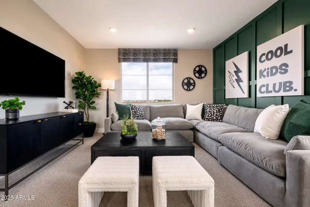 a living room with furniture a flat screen tv and a large window