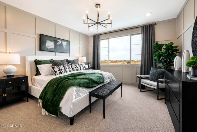 a bedroom with a bed and a large window