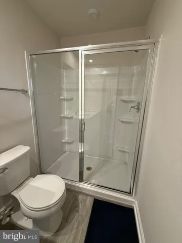 a bathroom with a toilet and a shower