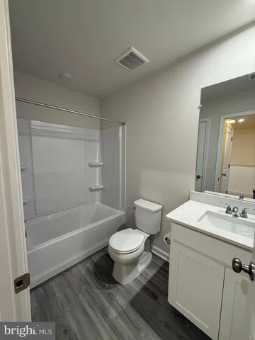 a bathroom with a sink toilet vanity and bathtub