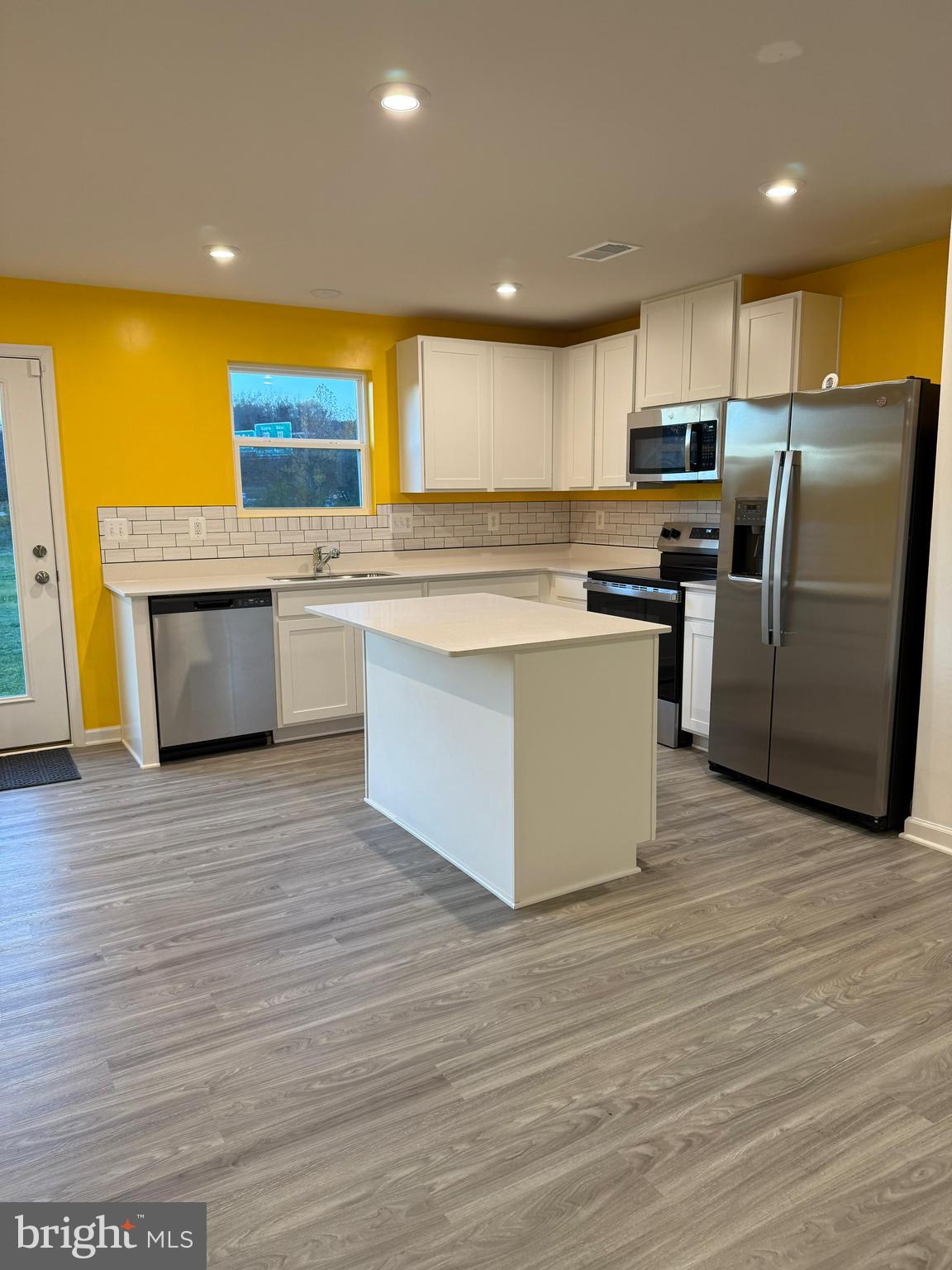 179 Olympus Road Charles Town, WV 25414 - Photo 3 of 26 a kitchen with stainless steel appliances a stove top oven a counter space and cabinets