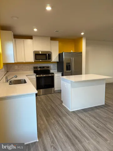 a kitchen with granite countertop a stove and a sink