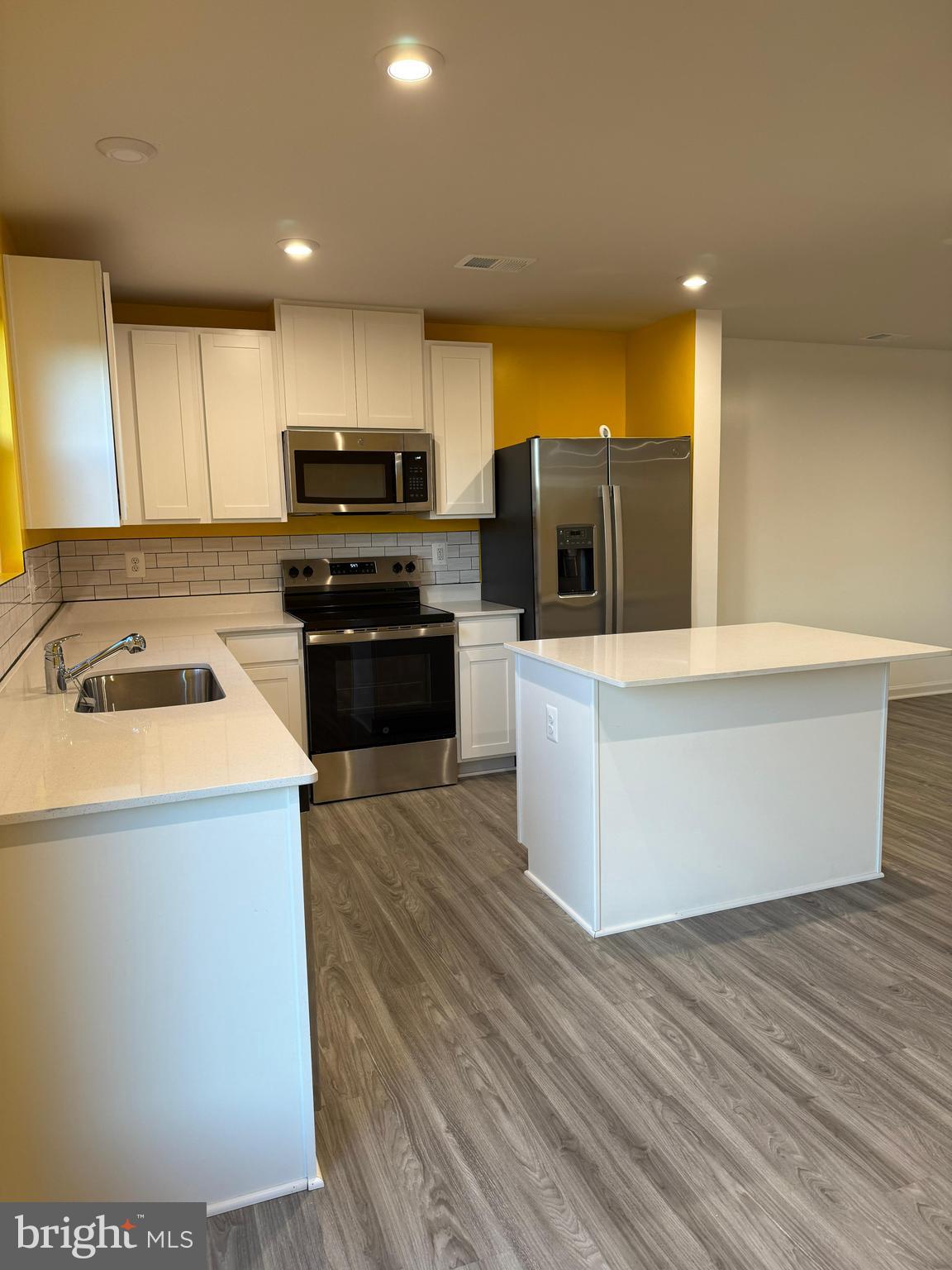 179 Olympus Road Charles Town, WV 25414 - Photo 4 of 26 a kitchen with granite countertop a stove and a sink