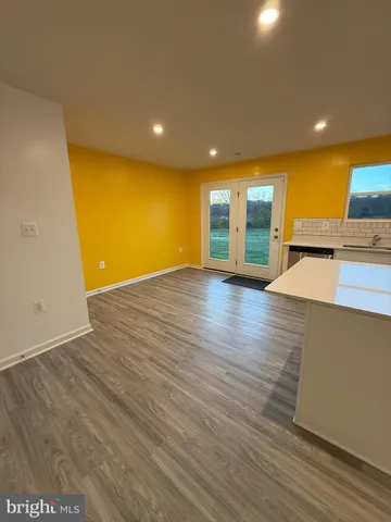 a view of a kitchen with a sink and a large window