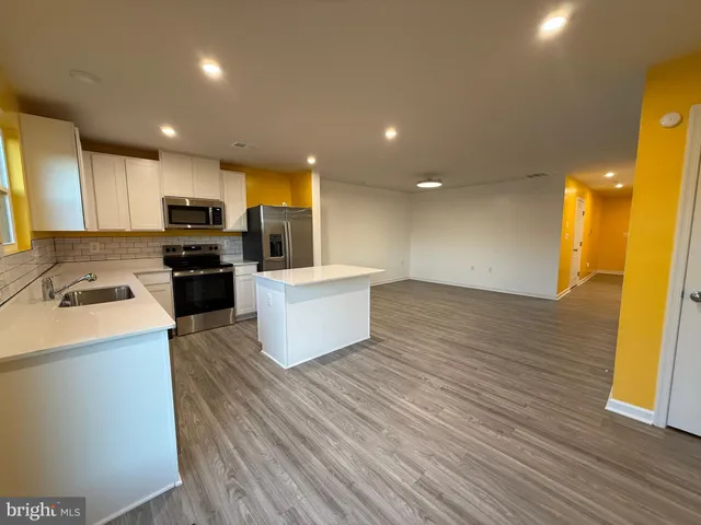 a view of kitchen with microwave oven and cabinets