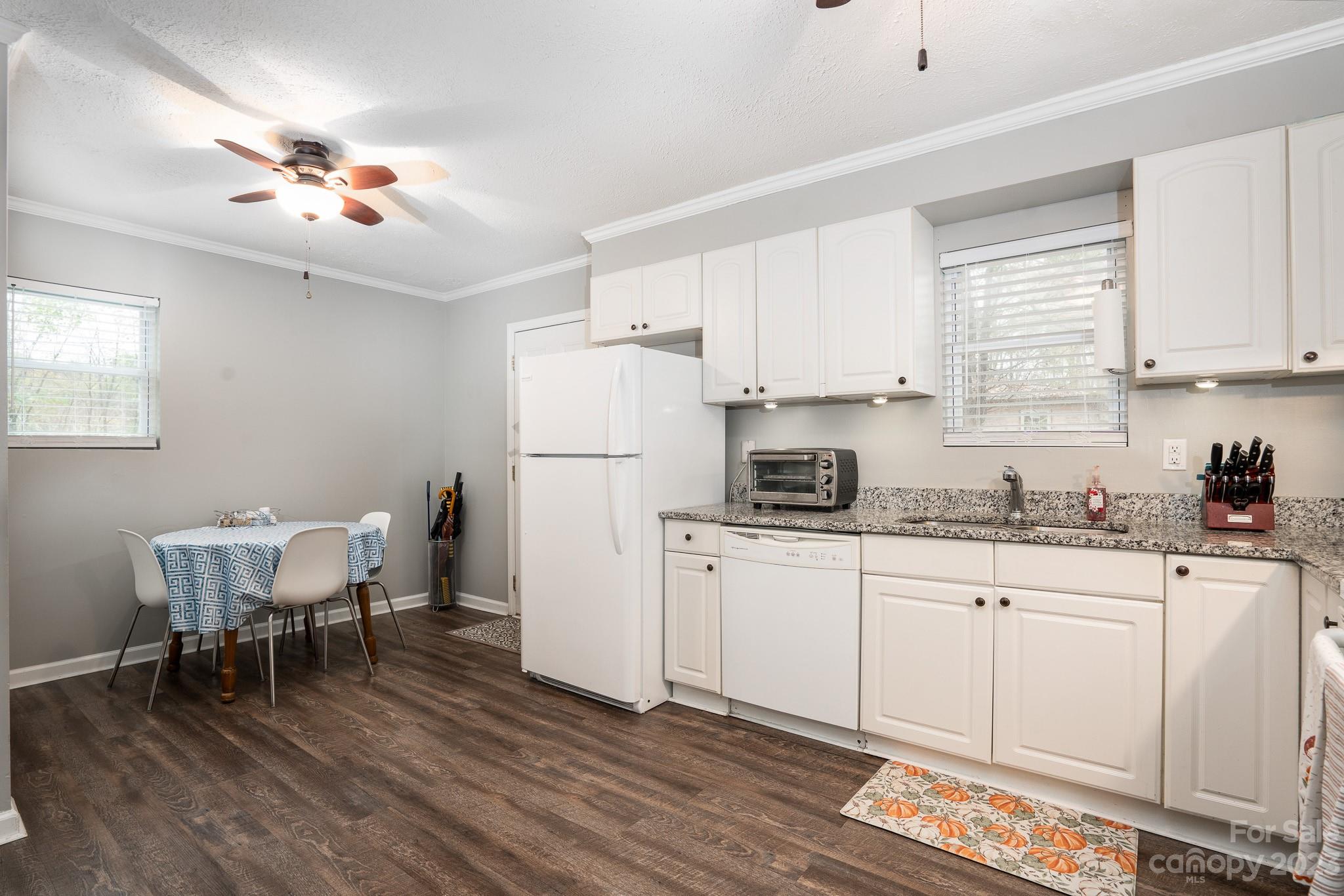 1250 B Street Mount Pleasant, NC 28124 - Photo 7 of 19 a kitchen with a white cabinets and chairs in it