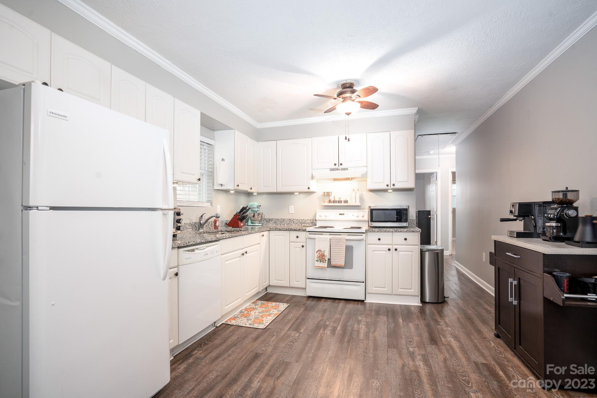 1250 B Street Mount Pleasant, NC 28124 - Photo 8 of 19 a kitchen with a sink a refrigerator and white cabinets