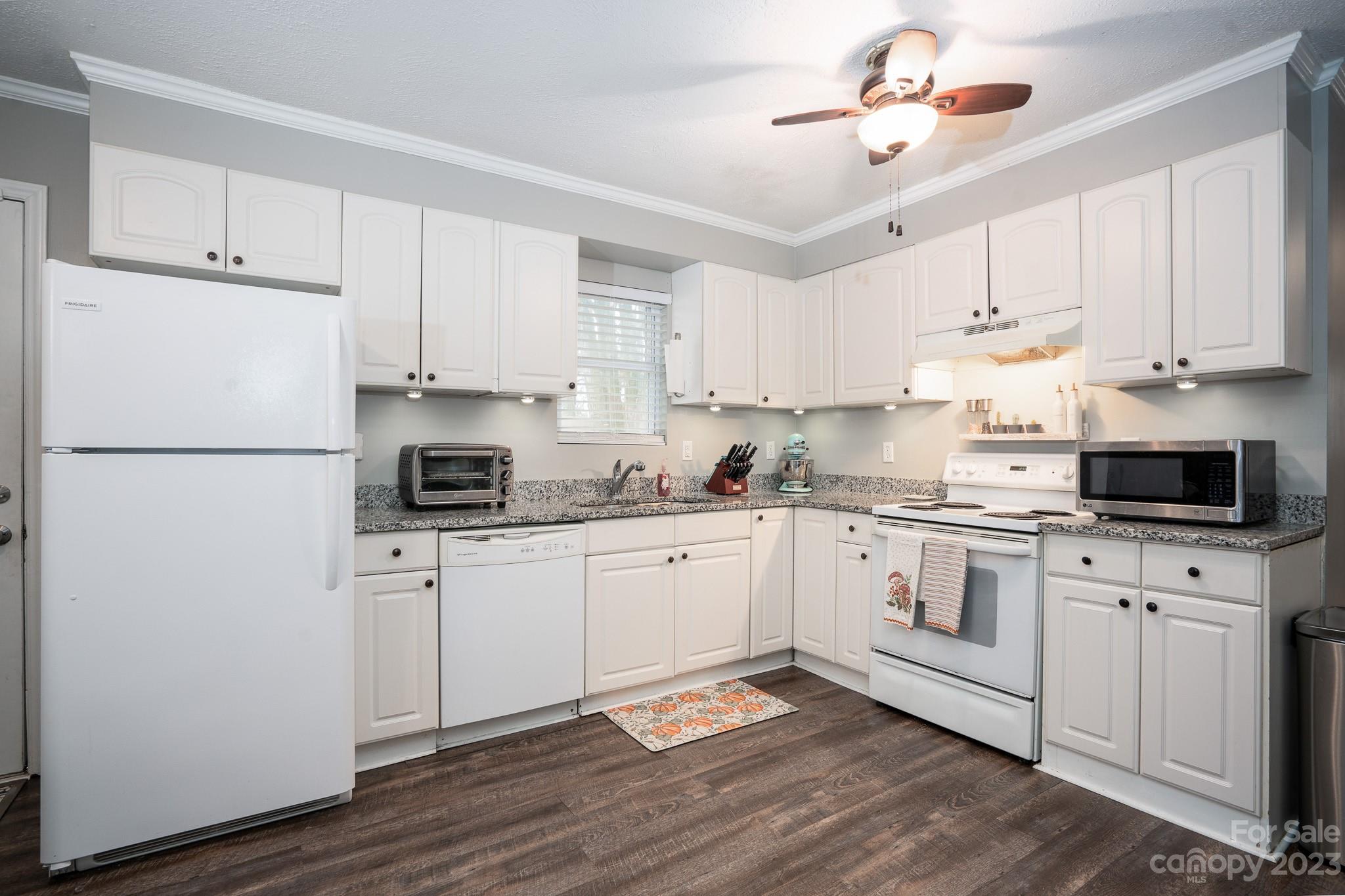 1250 B Street Mount Pleasant, NC 28124 - Photo 9 of 19 a kitchen with cabinets stainless steel appliances and wooden floors