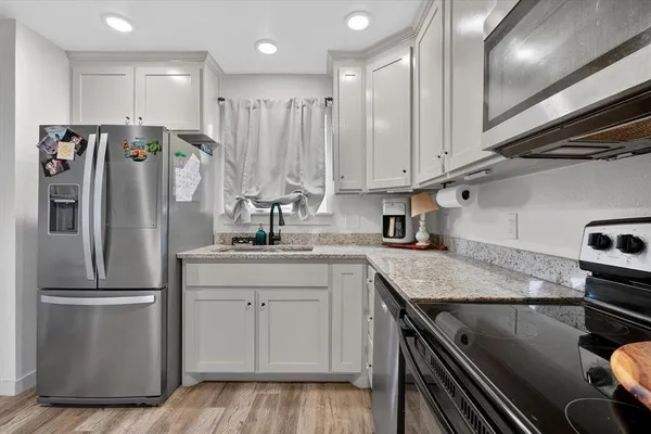 a kitchen with a refrigerator and a sink