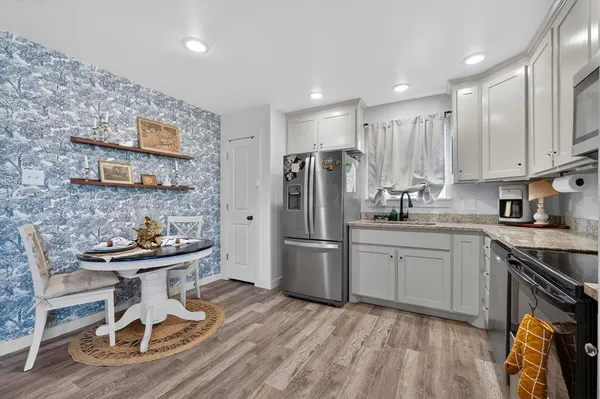 a kitchen with a sink appliances and cabinets