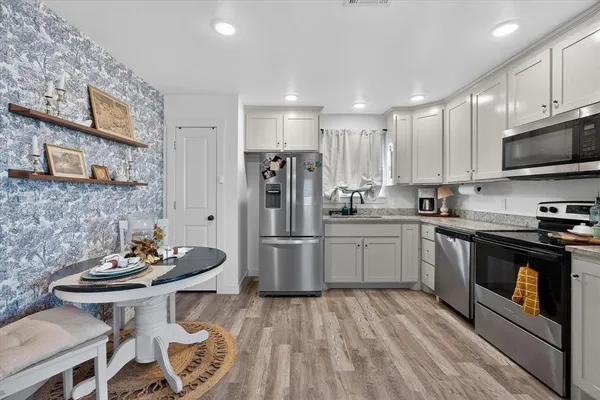 a kitchen with a sink cabinets and stainless steel appliances