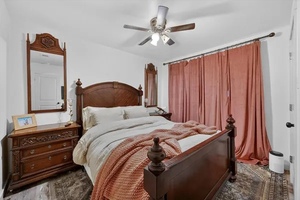 a bedroom with a bed and a chandelier