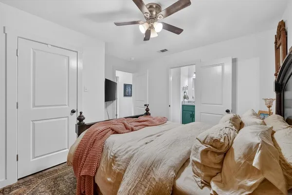 a bedroom with a bed and a chandelier
