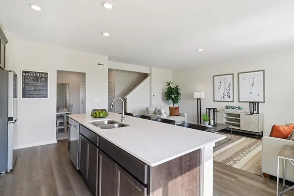a kitchen that has a lot of cabinets a sink and a stove in it