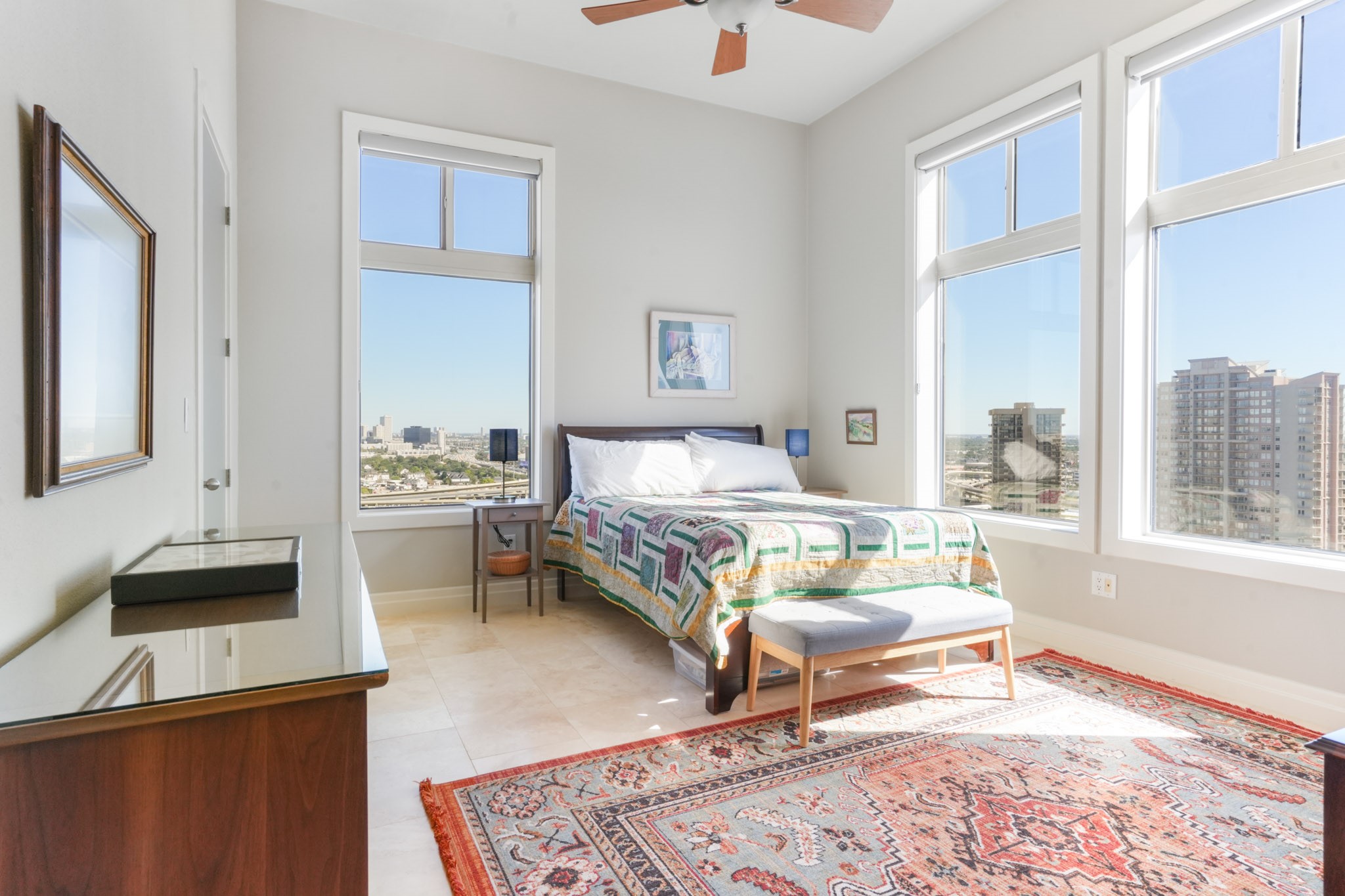 3388 Sage Road, Unit 2102 Houston, TX 77056 - Photo 18 of 21 Spacious secondary bedroom with ensuite bathroom features large windows allowing natural light to fill the space.