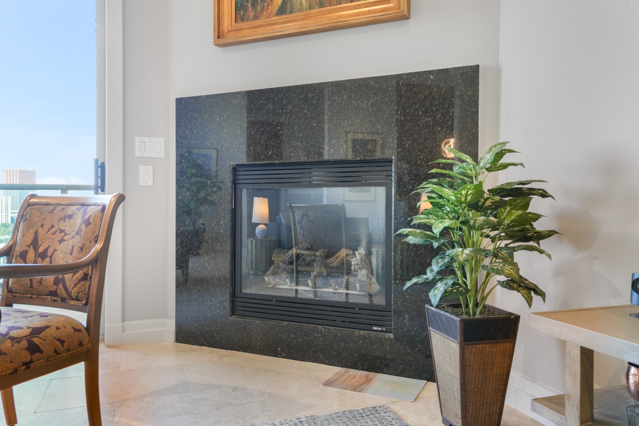 3388 Sage Road, Unit 2102 Houston, TX 77056 - Photo 5 of 21 Enjoy the ambiance of a cozy gas fireplace in the living room.