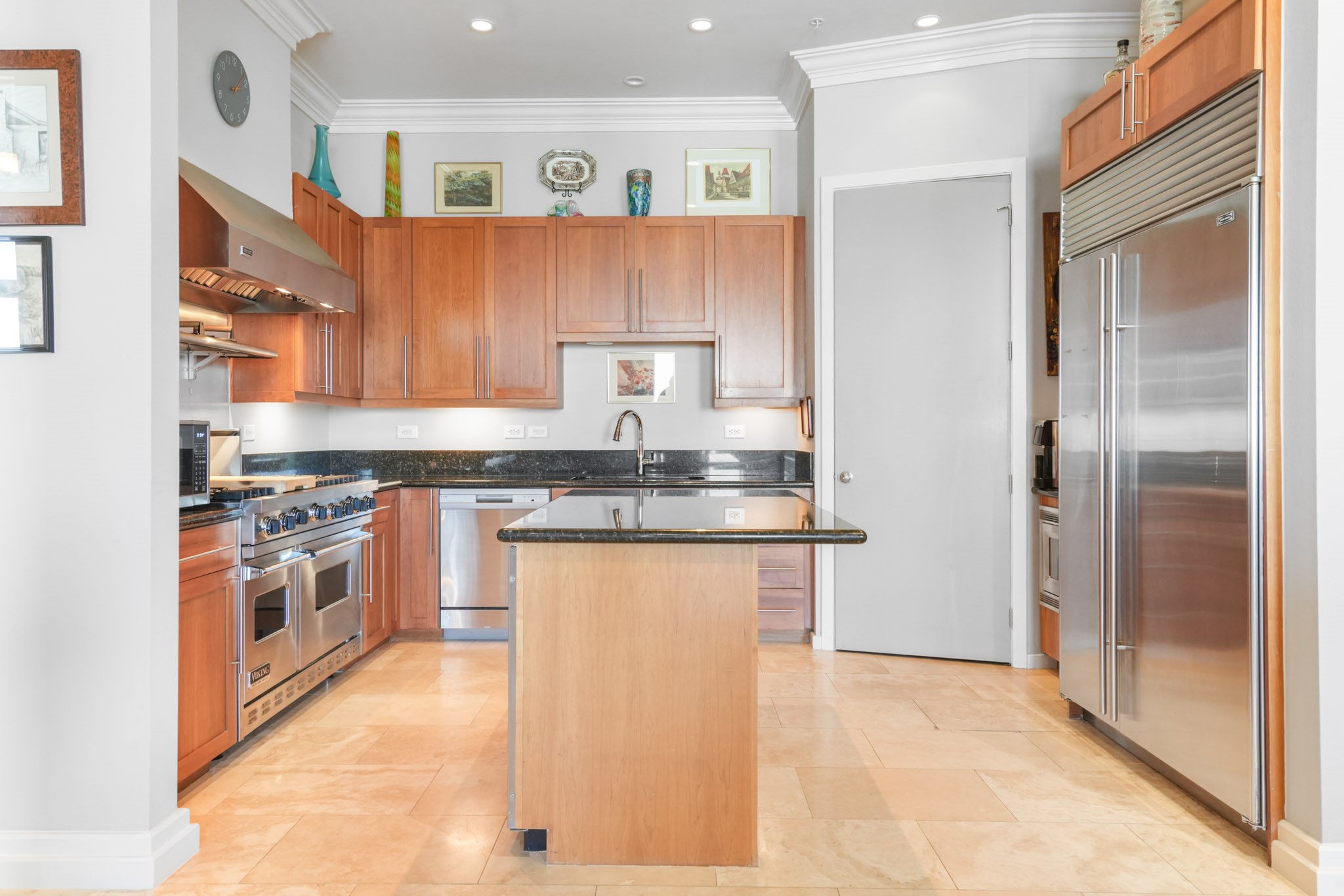 3388 Sage Road, Unit 2102 Houston, TX 77056 - Photo 6 of 21 Kitchen features a large island for meal prep and a Sub-Zero refrigerator and freezer.