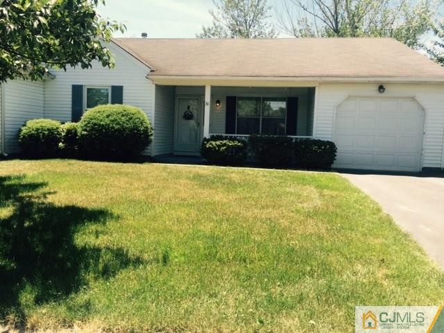 a view of a white house with a yard