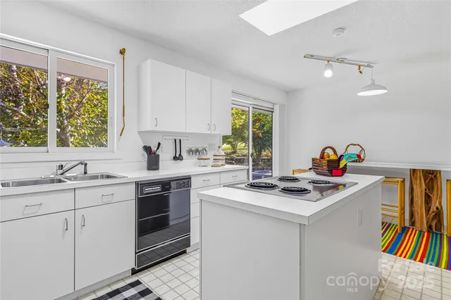 a kitchen with cabinets appliances and furniture