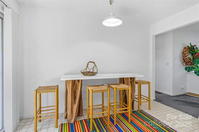 a dining room with furniture and a window