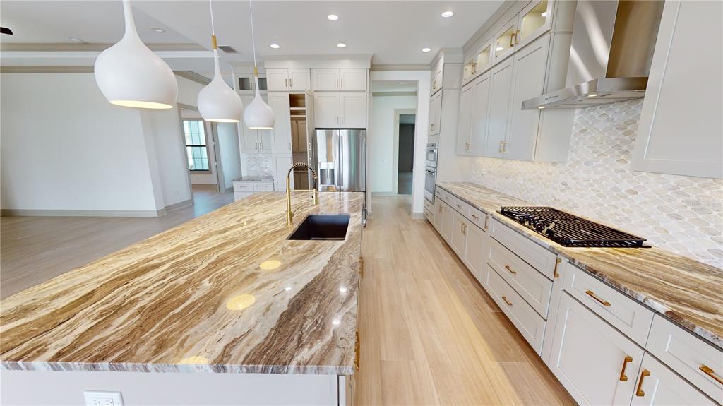 2033 Treasure Lane Punta Gorda, FL 33982 - Photo 14 of 63 a kitchen with stainless steel appliances granite countertop a refrigerator and a sink