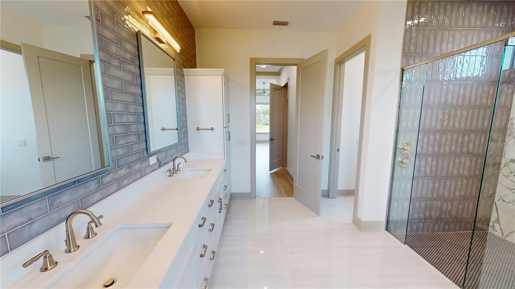 2033 Treasure Lane Punta Gorda, FL 33982 - Photo 27 of 63 a spacious bathroom with a double vanity sink mirror and shower