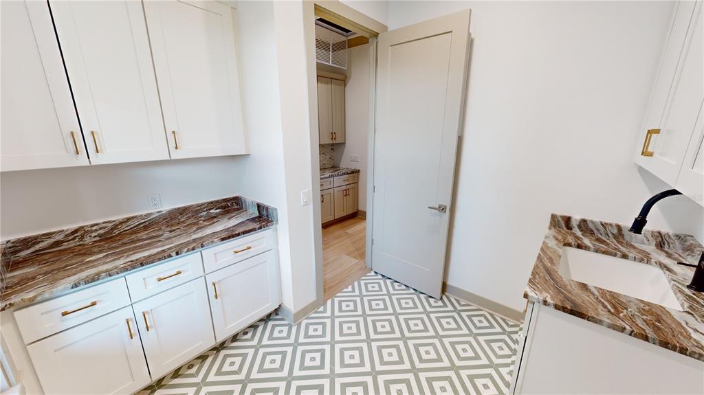 2033 Treasure Lane Punta Gorda, FL 33982 - Photo 36 of 63 a kitchen with a sink and cabinets