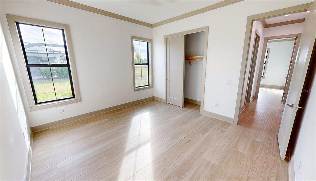 2033 Treasure Lane Punta Gorda, FL 33982 - Photo 40 of 63 an empty room with wooden floor and windows