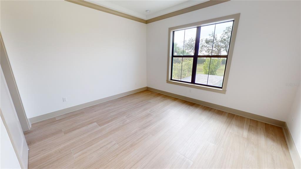2033 Treasure Lane Punta Gorda, FL 33982 - Photo 43 of 63 an empty room with wooden floor and windows