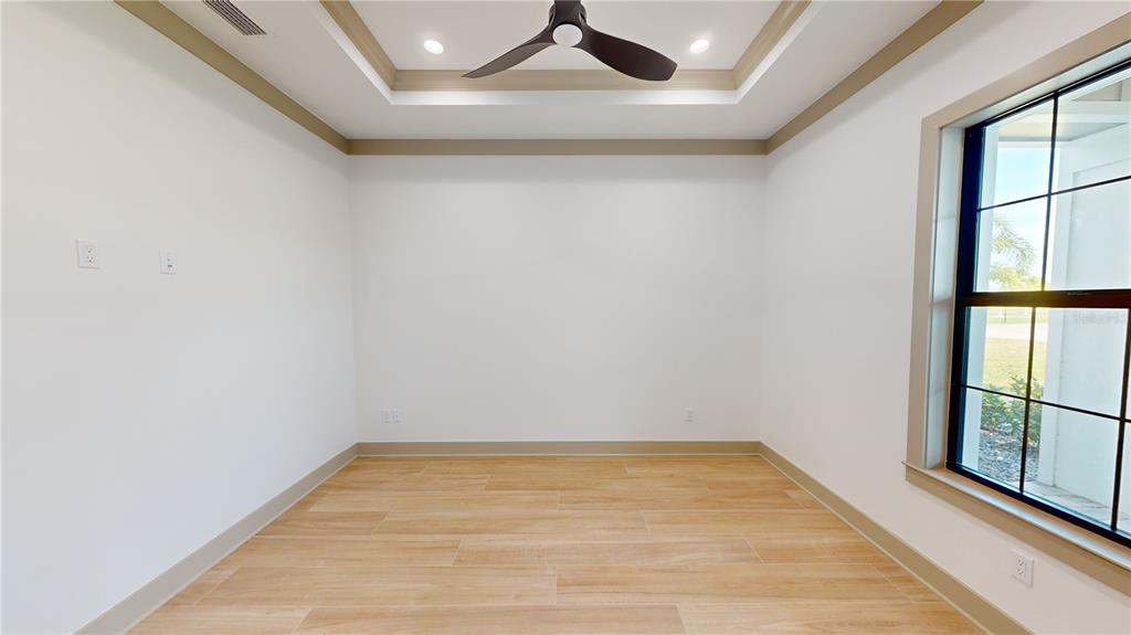 2033 Treasure Lane Punta Gorda, FL 33982 - Photo 7 of 63 a view of empty room with wooden floor and fan