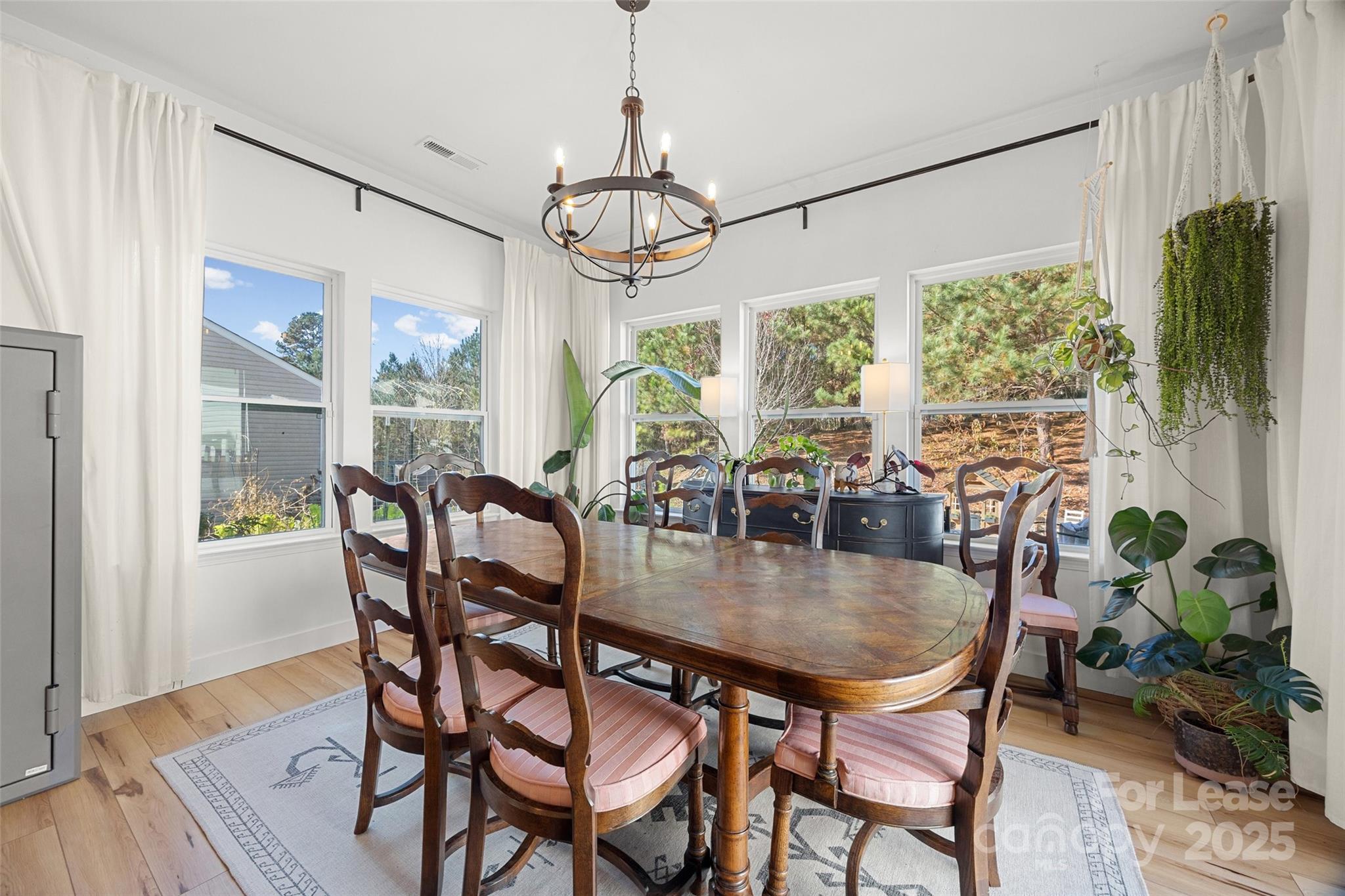 1668 Beleek Ridge Lane Clover, SC 29710 - Photo 12 of 42 a dining room with furniture a chandelier and wooden floor