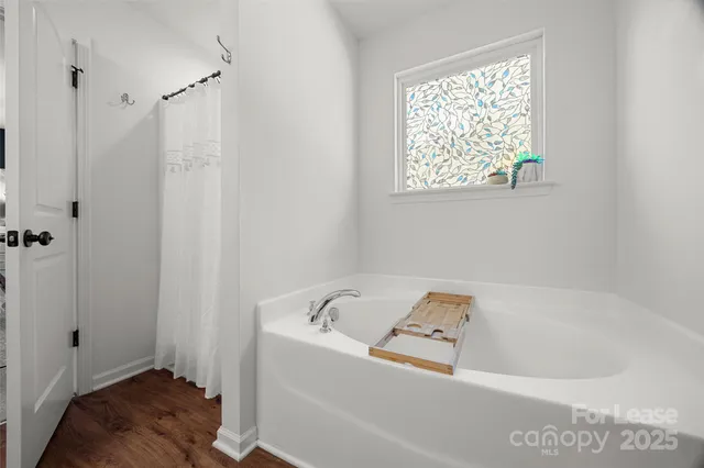 a bath tub sitting next to a window