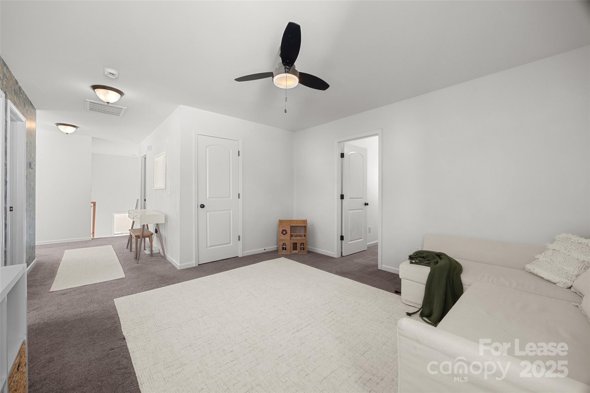 1668 Beleek Ridge Lane Clover, SC 29710 - Photo 21 of 42 a bedroom with a large bed and a chandelier