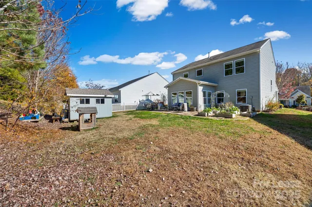 a view of a house with backyard and sitting area